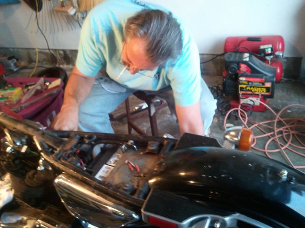 Rick in our garage working oin the 80 Ironhead Hd